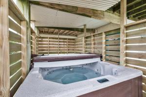 a sauna with a hot tub in the middle at 7030 - Waves Against the Machine in Rodanthe