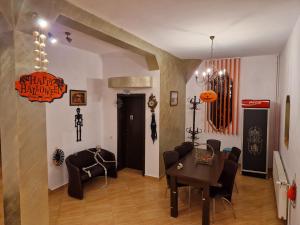 a living room with a dining room table and chairs at Casa Nobilă in Bran