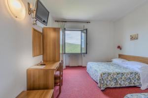 a hotel room with two beds and a window at B&B La Bufalona - Pool & Relax in Massa Marittima +36 photos