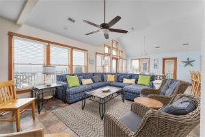 a living room with a blue couch and chairs at 7677 - Weathering Heights in Avon