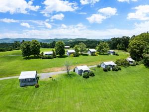 an aerial view of a farm with houses and a road at Private Mountain Nook with Jacuzzi - Cabin 6 in Fancy Gap +19 photos