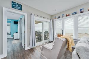 a living room with a couch and some windows at 7660 - Robyn's Nest in Avon +14 photos