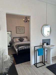 a bedroom with a bed and a sink and a mirror at Casa Santo Antonio in Pias