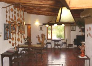 a dining room with tables and chairs and a window at Huaira Huasi in Purmamarca