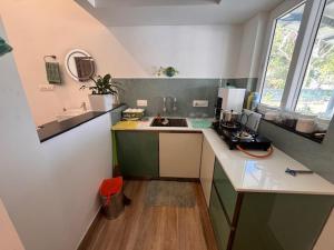 a small kitchen with a sink and a counter at River Breeze Cherai in Cochin