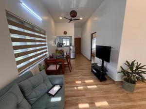 a living room with a couch and a dining room at River Breeze Cherai in Cochin