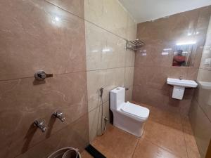a bathroom with a toilet and a sink at River Breeze Cherai in Cochin +35 photos
