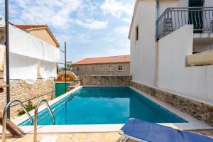 a swimming pool in the middle of a building at Holiday house with a swimming pool - Villa Melavita in Stari Grad