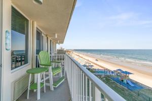 a balcony with chairs and a view of the beach at Daytona Beach in Daytona Beach