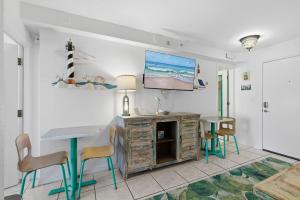 a living room with a table and chairs and a tv at Daytona Beach in Daytona Beach