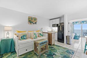a living room with a couch and a kitchen at Daytona Beach in Daytona Beach