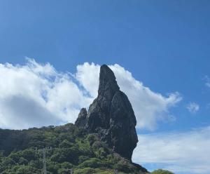 a tall mountain on top of a green hill at Casa do Val in Fernando de Noronha