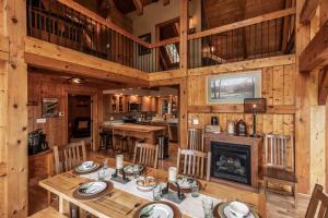 a dining room with a table and a fireplace at Shady Maples Lodge in Townsend