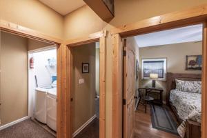 a bedroom with a door open to a room with a bed at Shady Maples Lodge in Townsend +71 photos