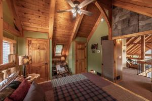a bedroom with a bed and a ceiling fan at Shady Maples Lodge in Townsend