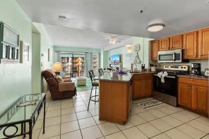a kitchen with an island in the middle of a room at The Palace Resort #1114 in Myrtle Beach