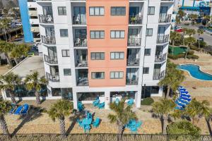 an aerial view of a building with chairs and a pool at The Palace Resort #1114 in Myrtle Beach