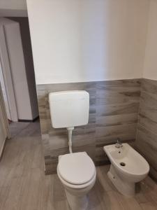 a bathroom with a white toilet and a sink at sunflower apartment in Domaso +26 photos