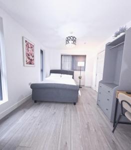 a white bedroom with a bed and a dresser at C- Spacious En-Suite Room Sheffield Centre in Victoria