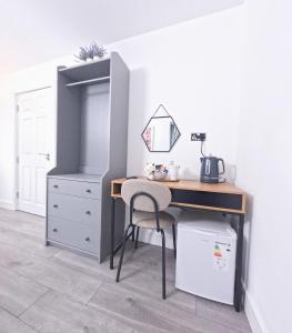 a desk with a chair next to a dresser at C- Spacious En-Suite Room Sheffield Centre in Victoria