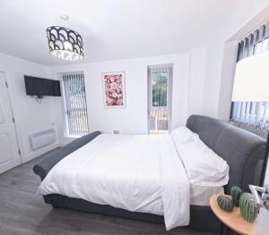 a bedroom with a large bed and a couch at C- Spacious En-Suite Room Sheffield Centre in Victoria +4 photos
