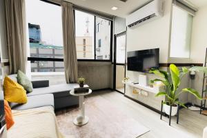 a living room with a couch and a tv at Cozy 1BHK Apartment in Central Malé in Male City
