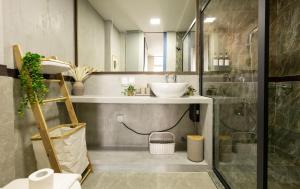 a bathroom with a sink and a shower at Cozy 1BHK Apartment in Central Malé in Male City