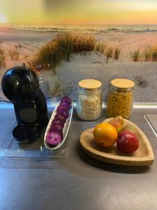a table with fruits and vegetables and jars of food at Apartment am Waldrand Nichtraucher gemütlich und ruhig in Itzehoe