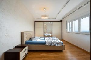 a bedroom with a bed and a dresser and a window at Lux Apartment "Lea" in Kotor