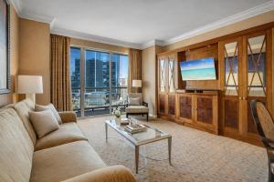 a living room with a couch and a tv at MGM Signature Tower 2 8th Floor 2-Suite Strip View Balcony No Resort Fee in Las Vegas