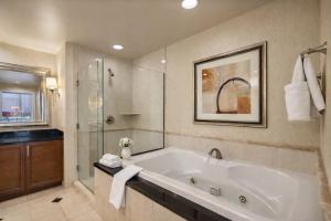 a large bathroom with a tub and a shower at MGM Signature Tower 2 8th Floor 2-Suite Strip View Balcony No Resort Fee in Las Vegas