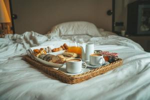 a tray of breakfast foods and coffee on a bed at Opera Boutique B&B in Florence