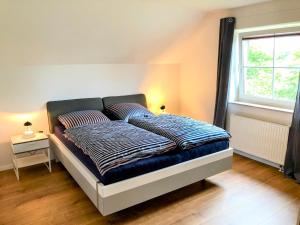 a bed with two pillows on it in a bedroom at Ferienhaus Emilius in Butjadingen