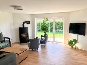 a living room with a couch and a fireplace at Ferienhaus Emilius in Butjadingen +14 photos