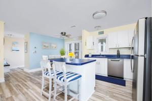 a kitchen with white cabinets and a blue counter top at 7662 - Sea La Vie in Avon
