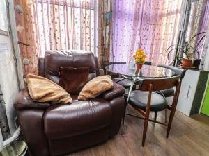 a leather chair sitting next to a glass table at Number 3 in Blackpool