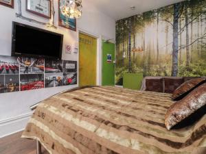 a bedroom with a large bed and a flat screen tv at Number 3 in Blackpool