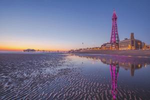 a view of the beach at sunset with a tower at Number 3 in Blackpool
