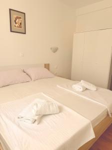 a bedroom with two beds with towels on them at Apartments Niko Novalja in Novalja