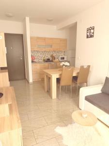 a living room and kitchen with a table and chairs at Apartments Niko Novalja in Novalja