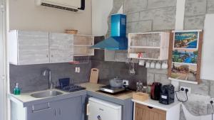 a kitchen with a sink and a counter top at Efi studios in Kardamaina