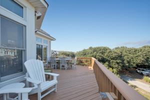 a deck with chairs and tables on a house at 4482 - Villa Al Mare in Duck