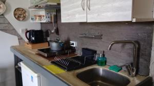 a kitchen counter top with a sink and a sink at Efi studios in Kardamaina