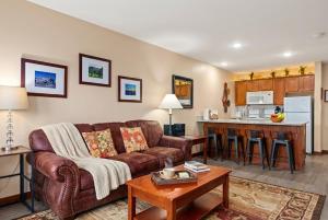 a living room with a couch and a kitchen at AS 326 No Resort Fee Pool-View Ski-InOut in Snowshoe