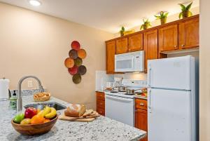 a kitchen with a white refrigerator and a bowl of fruit at AS 326 No Resort Fee Pool-View Ski-InOut in Snowshoe