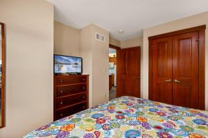 a bedroom with a bed and a dresser at AS 326 No Resort Fee Pool-View Ski-InOut in Snowshoe +33 photos