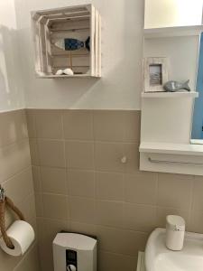 a small bathroom with a toilet and a mirror at lüttjeseeblick13 in Nordstrand +35 photos