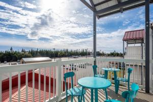 a balcony with tables and chairs and a view at Snowshoe Ski-InSki-Out Steps to Ballhooter Lift Mountain Lodge Condo in Snowshoe