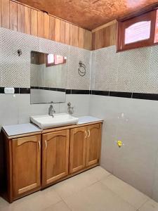 a bathroom with a sink and a mirror at Hospedaje Cabañas Wohlrab in Oxapampa