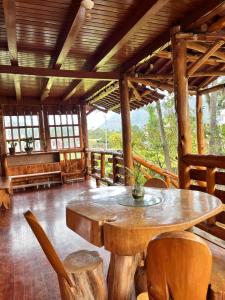 a large wooden room with a table and chairs at Hospedaje Cabañas Wohlrab in Oxapampa